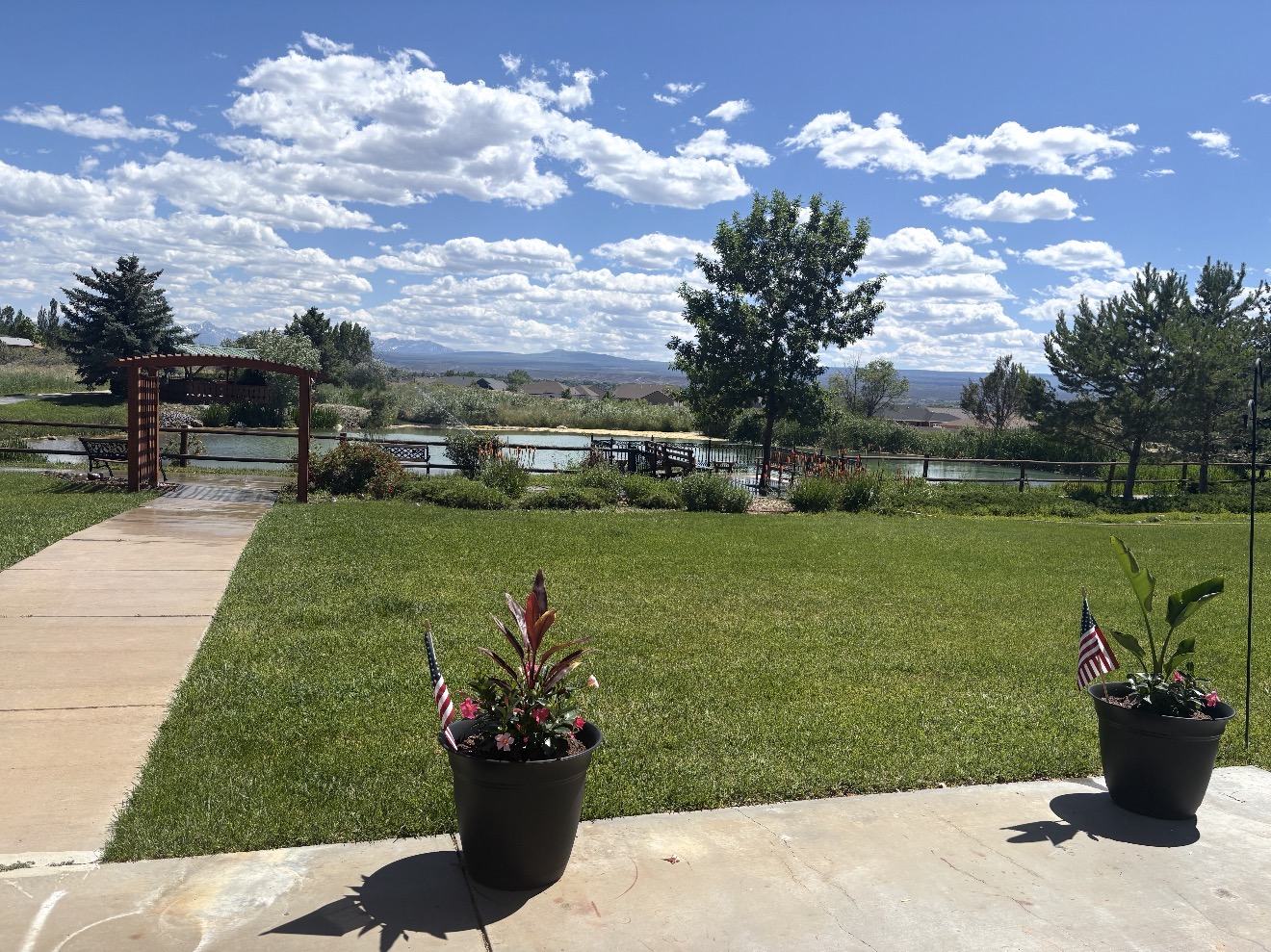 Landscaped grounds, fishpond and San Juan Mountain views at Spring Creek Chalet